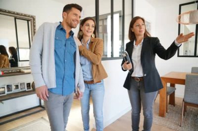 A real estate agent takes a couple on a tour of a beautiful home for sale in Boulder, Colorado